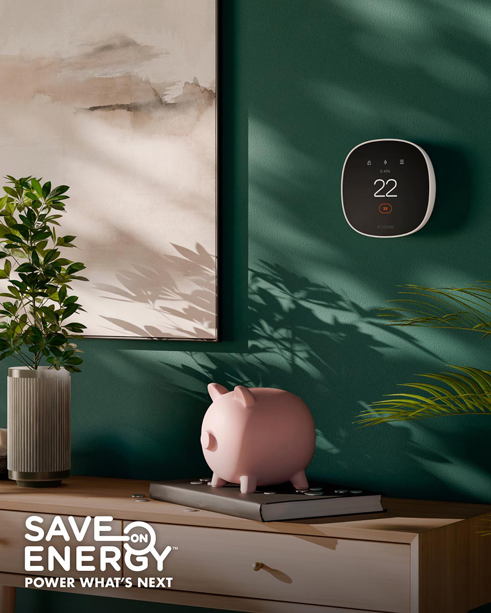 A piggy bank on a table underneath a modern thermostat on the wall